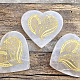 White selenite heart with an engraved plant motif