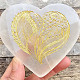 White selenite heart with an engraved plant motif