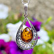 Amber honey pendant decorated with silver Ag 925/1000