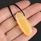 Calcite an orange elongated pendant on the leather